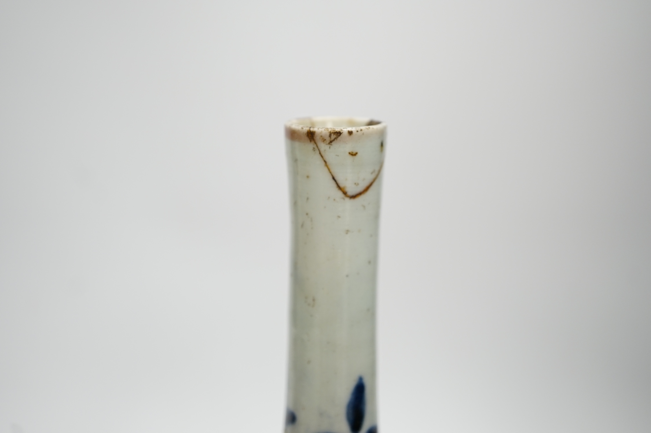A pair of Japanese Arita bottle vases, c.1700, 24cm. Condition - heavily crazed, one with small section of neck broken and reglued